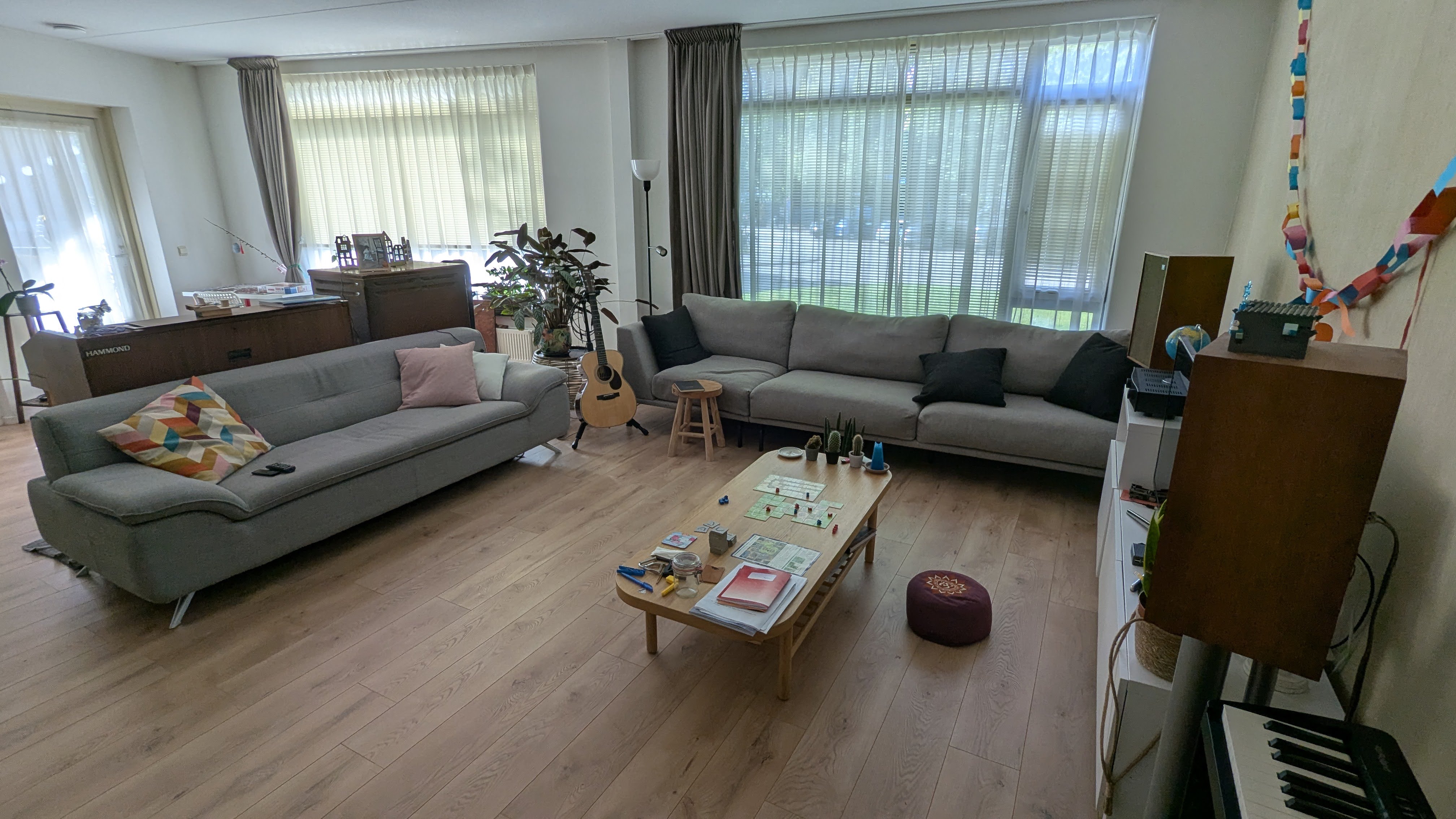 Two large couches with an acoustic guitar between them